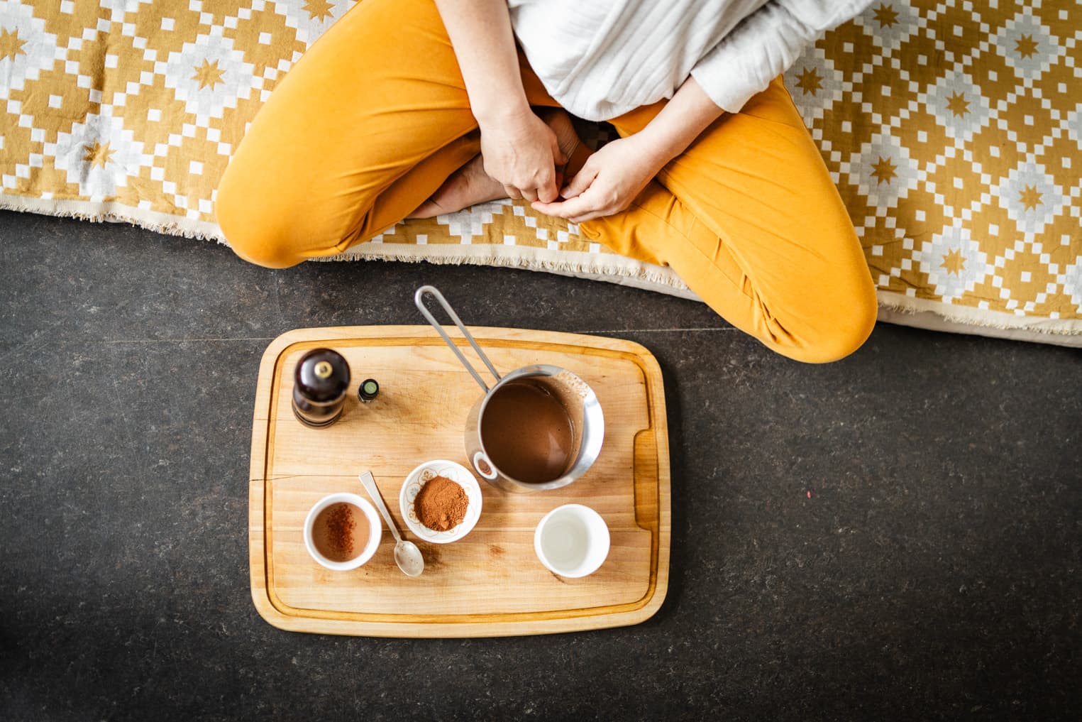Detailaufnahme: Tablet mit Zutaten für Cacao-Zubereitung, Hände und Utensilien sichtbar